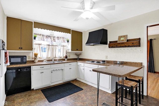 kitchen with sink, ventilation hood, kitchen peninsula, white cabinets, and black appliances