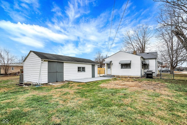 rear view of property featuring a lawn and a patio