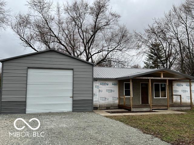 exterior space with gravel driveway and a porch