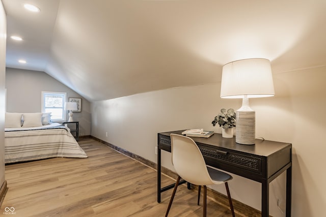 bedroom with vaulted ceiling and light hardwood / wood-style floors