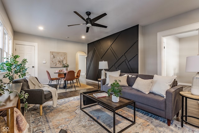 living room with ceiling fan and hardwood / wood-style floors