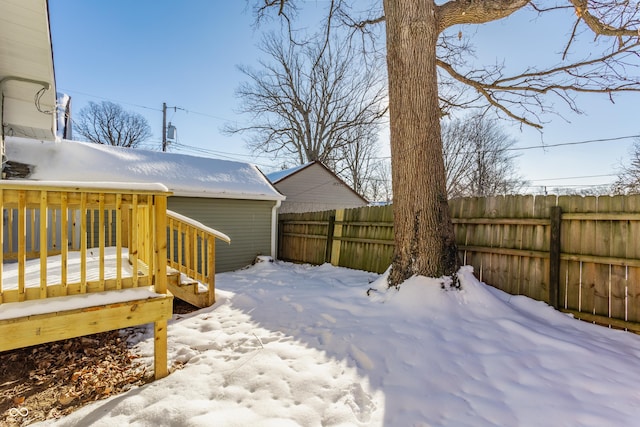 yard layered in snow with a wooden deck