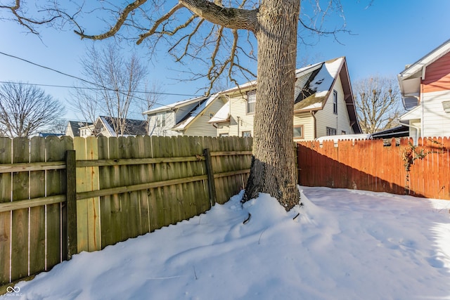 view of yard layered in snow