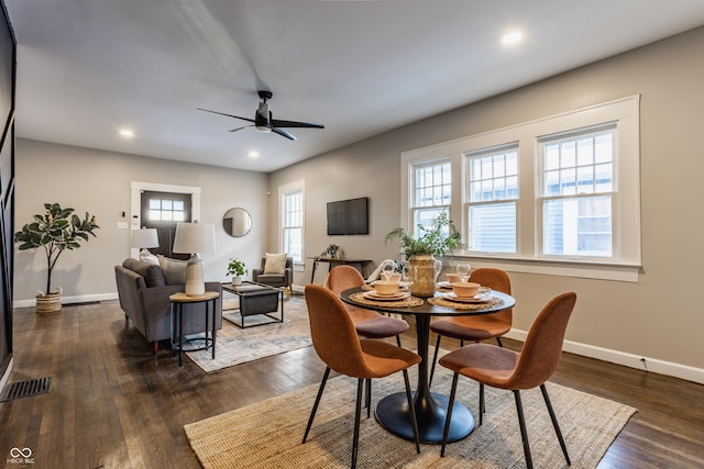 dining room featuring ceiling fan, a wealth of natural light, and dark hardwood / wood-style flooring