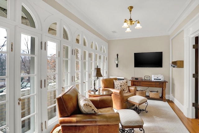 sunroom / solarium with a chandelier