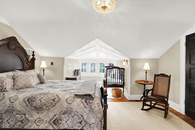 bedroom featuring hardwood / wood-style floors and lofted ceiling