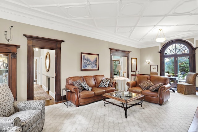 living room featuring hardwood / wood-style floors, coffered ceiling, and ornamental molding