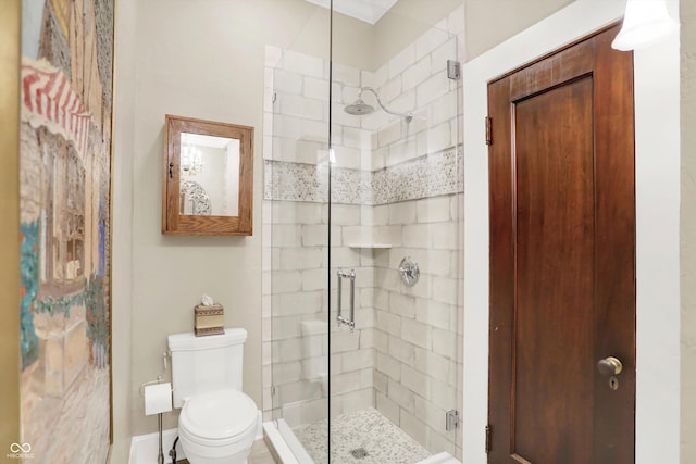 bathroom featuring toilet and a shower with shower door