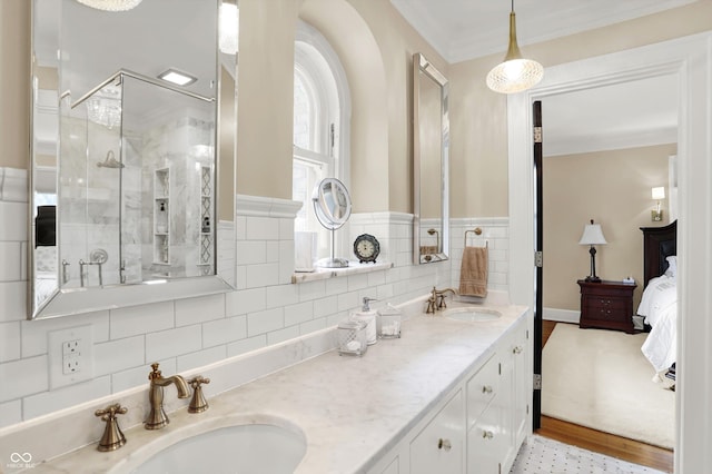 bathroom featuring crown molding, vanity, a shower with shower door, and hardwood / wood-style flooring