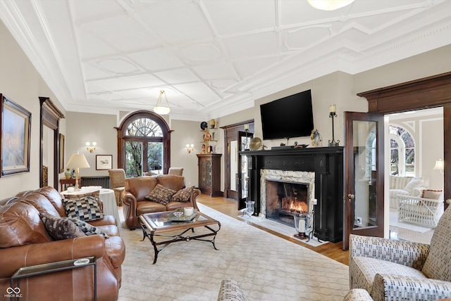 living room featuring light wood-type flooring and ornamental molding