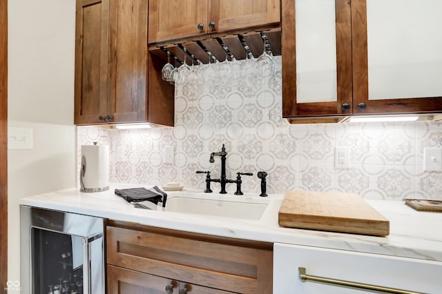 kitchen featuring sink, beverage cooler, and tasteful backsplash