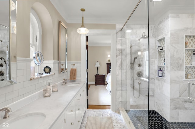 bathroom with vanity, an enclosed shower, and crown molding