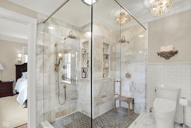 bathroom with a chandelier, a shower with shower door, tile walls, and toilet