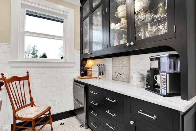 bar with tile patterned flooring and light stone counters