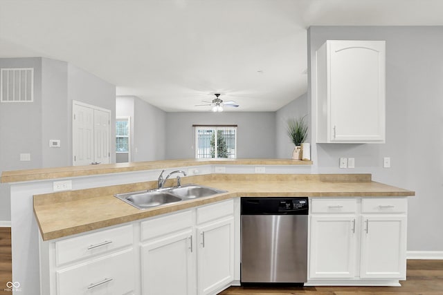 kitchen featuring ceiling fan, dishwasher, sink, kitchen peninsula, and white cabinets