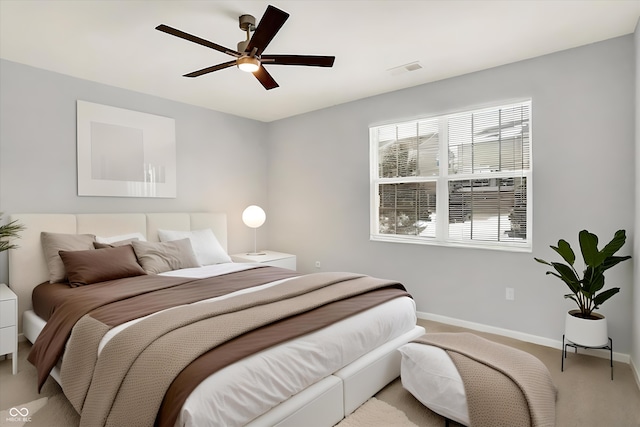 bedroom featuring ceiling fan and light carpet