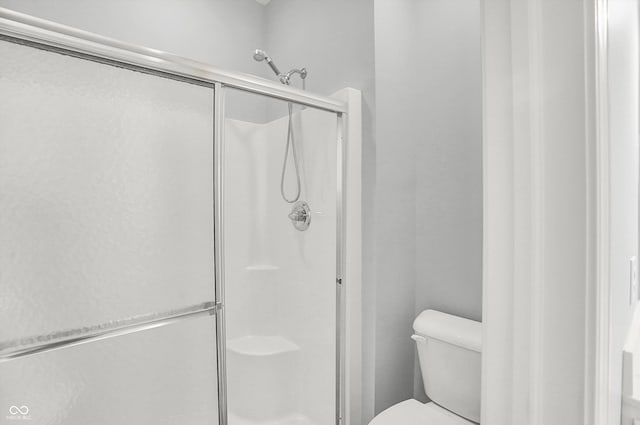 bathroom with toilet and walk in shower