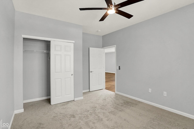 unfurnished bedroom featuring ceiling fan, a closet, and light carpet