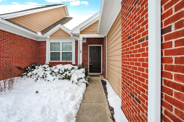 view of snow covered property entrance