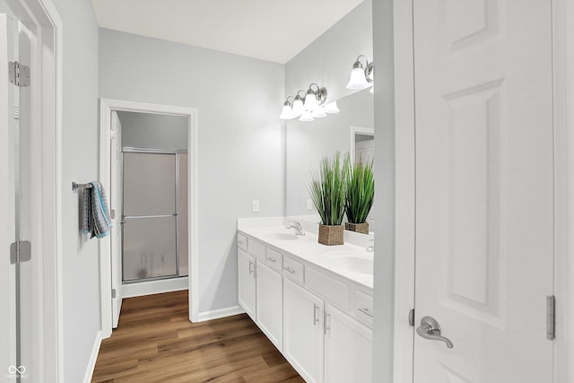 bathroom featuring hardwood / wood-style floors, vanity, and walk in shower