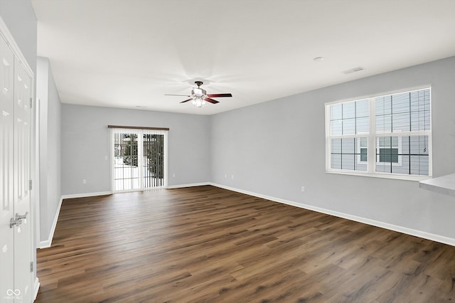 empty room featuring ceiling fan and dark wood-type flooring