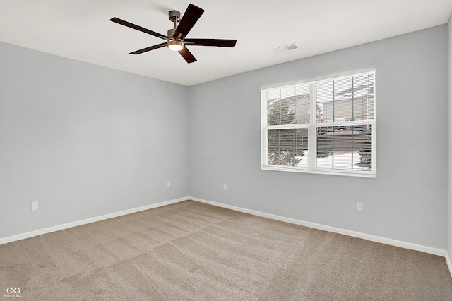 carpeted spare room with ceiling fan