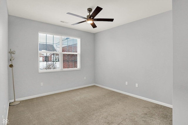 carpeted spare room featuring ceiling fan