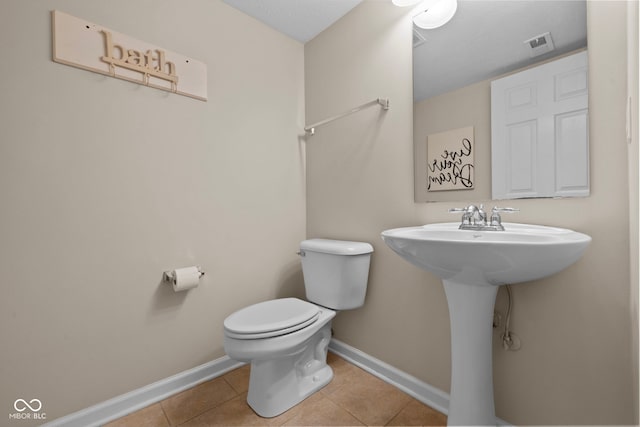 bathroom with tile patterned flooring and toilet