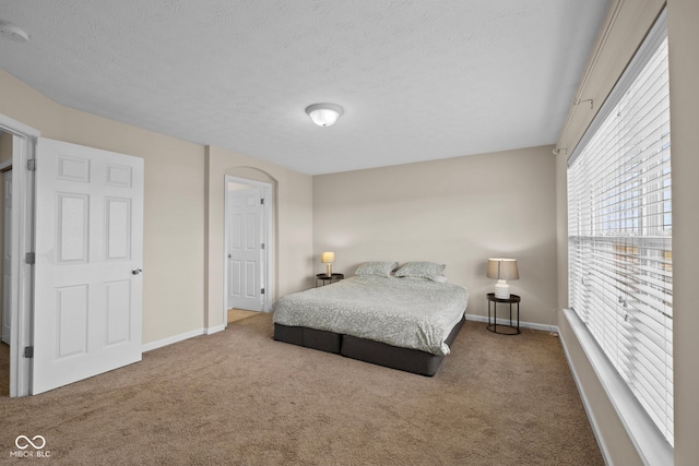 carpeted bedroom featuring a textured ceiling