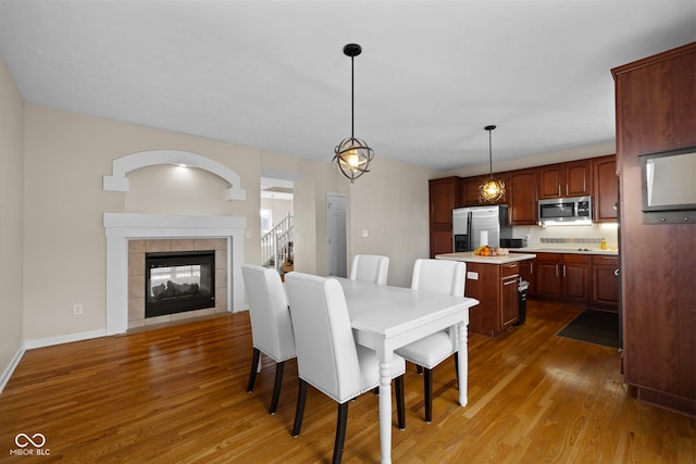 dining area with dark hardwood / wood-style flooring and a fireplace