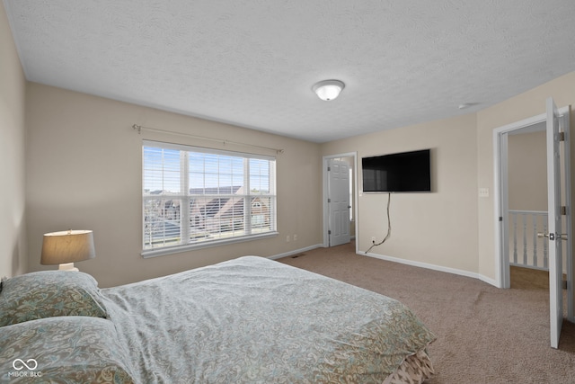 bedroom with a textured ceiling and carpet floors