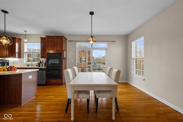 dining area with hardwood / wood-style flooring and sink