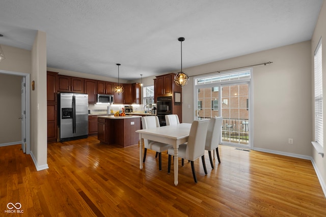 dining space featuring a textured ceiling and dark hardwood / wood-style flooring