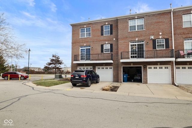 townhome / multi-family property featuring central air condition unit and a garage