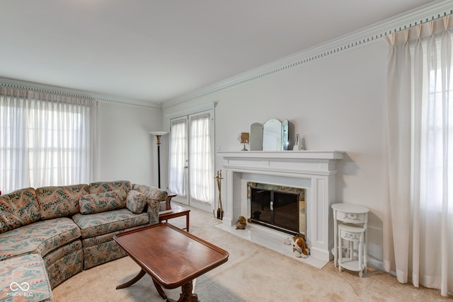 living room featuring plenty of natural light, light colored carpet, a premium fireplace, and ornamental molding