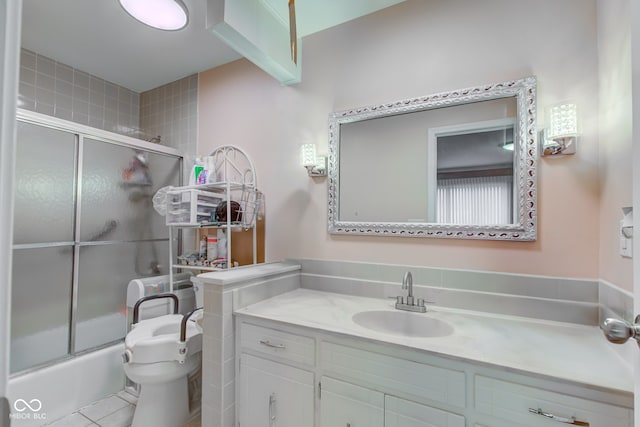 full bathroom with toilet, vanity, tile patterned floors, and enclosed tub / shower combo