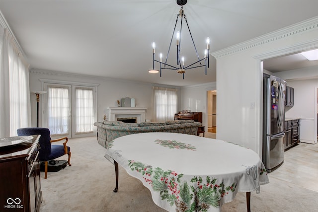 carpeted dining space featuring crown molding, plenty of natural light, and french doors