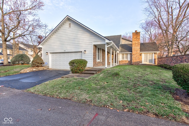 view of front of house with a front lawn and a garage