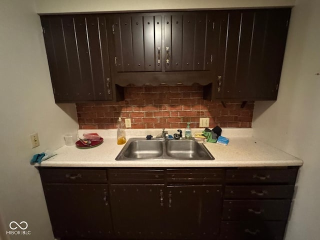 kitchen featuring dark brown cabinetry and sink