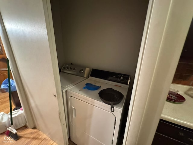 laundry room with light hardwood / wood-style floors and independent washer and dryer