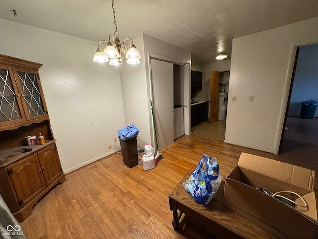 dining space featuring a notable chandelier and light wood-type flooring