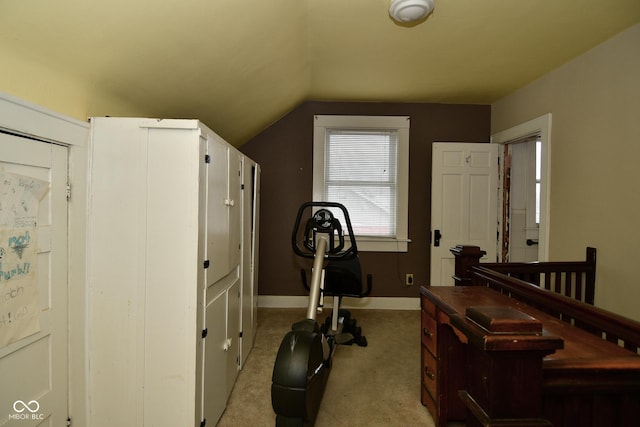 exercise room with light carpet and lofted ceiling