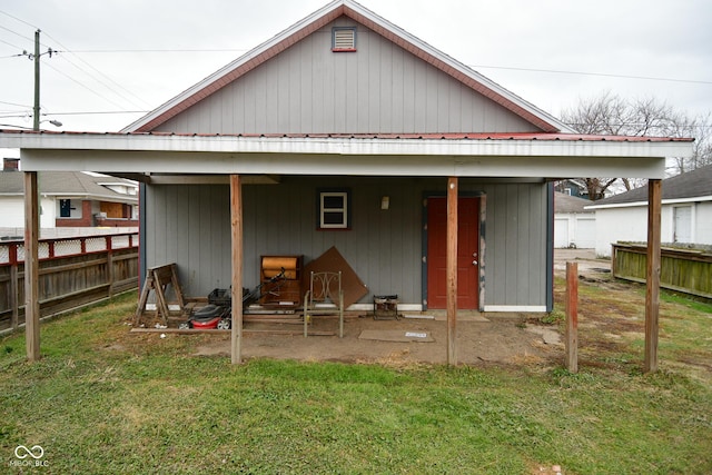 rear view of property with a yard