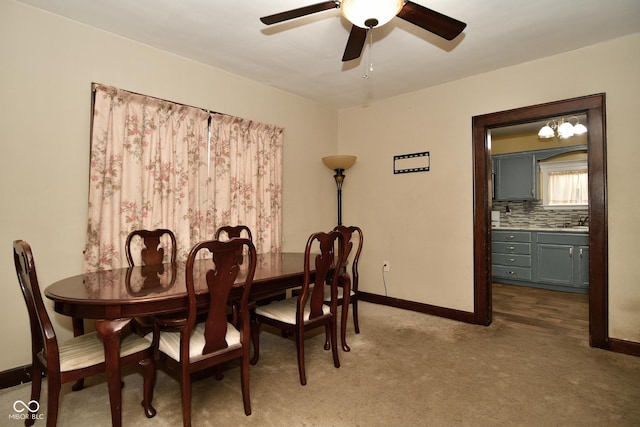 carpeted dining area featuring ceiling fan