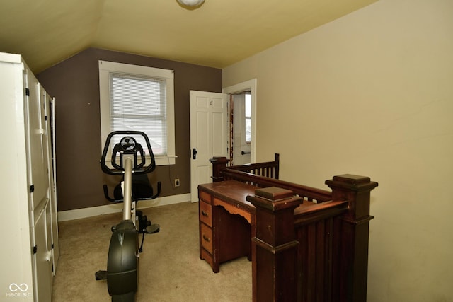 carpeted office featuring vaulted ceiling