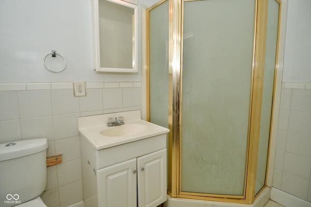 bathroom featuring vanity, toilet, and walk in shower