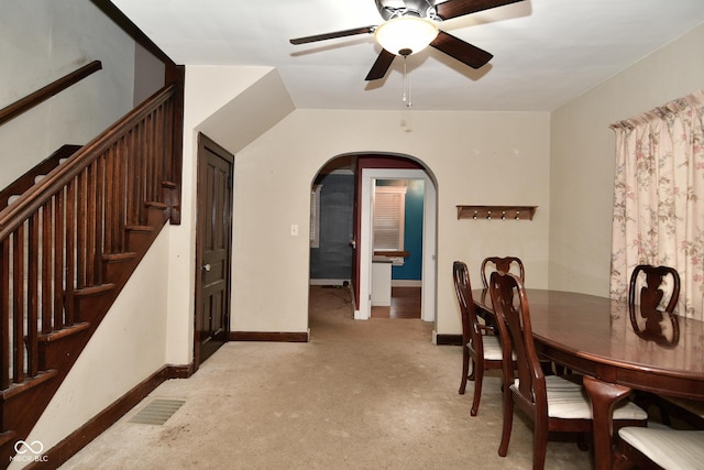 dining room featuring ceiling fan and light carpet