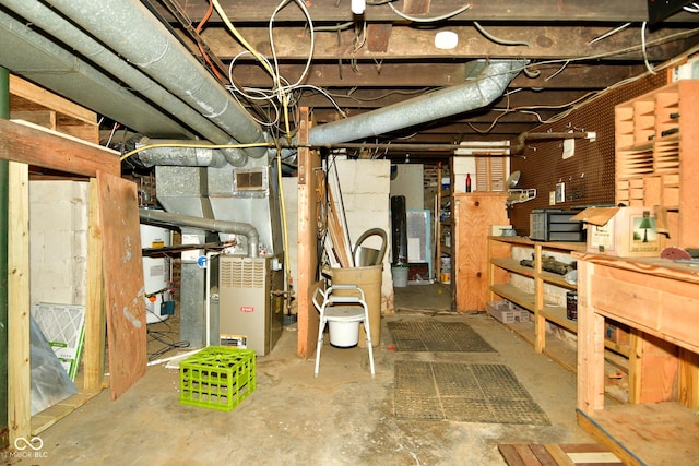 basement featuring gas water heater and heating unit