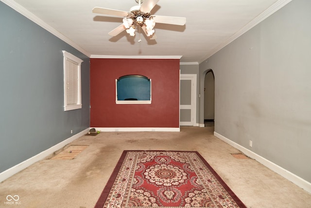 unfurnished room with carpet, ceiling fan, and crown molding