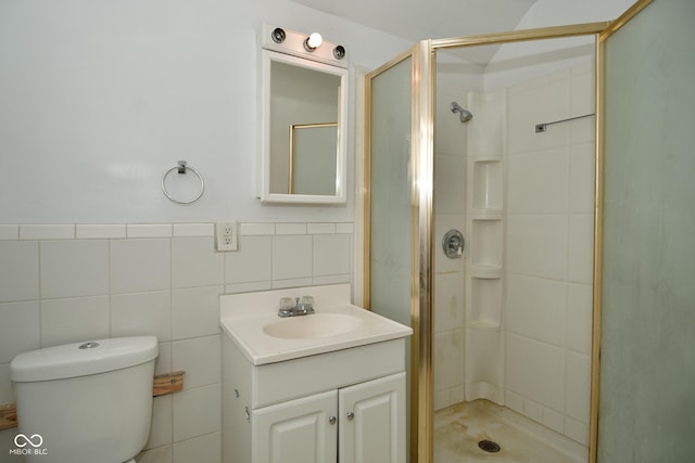 bathroom featuring vanity, toilet, an enclosed shower, and tile walls